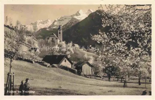 AK / Ansichtskarte Flueelen UR Fruehling Kirche Kirschbluete Berge Wiesen Dorf Frauen Hotel-Tell-Post