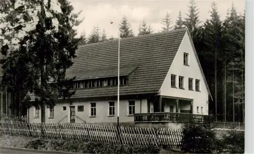 AK / Ansichtskarte Hirschhagen Hessisch Lichtenau Hessen Ernst-Paulus-Heim Jugendheim Nadelwald Gebaeude Zaun Flaggenmast