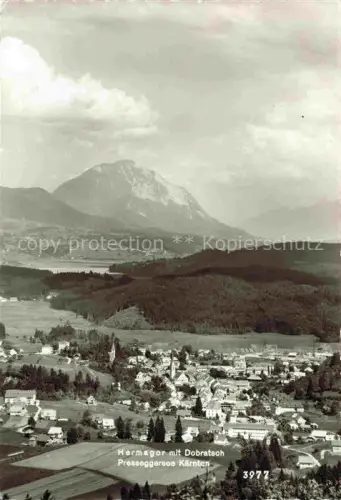 AK / Ansichtskarte Hermagor Kaernten AT Dobratsch Presseggersee Panorama Ortschaft Kirche Bergmassiv Wald