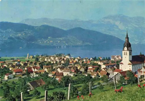 AK / Ansichtskarte Buochs Vierwaldstaettersee Kirche Ortschaft Berge Wiesen Fliegeraufnahme