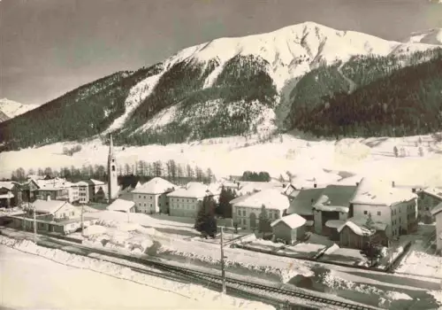 AK / Ansichtskarte S-chanf GR Winter Kirche Dorf Engadin Piz-Murter Berge Schnee Eisenbahn