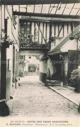 AK / Ansichtskarte Les Andelys 27 Eure Hôtel-des-Trois-Marchands Innenhof Fachwerk Kopfsteinpflaster Blumenschmuck Durchgang