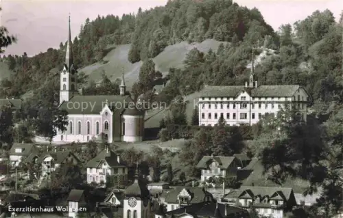 AK / Ansichtskarte Wolhusen Sursee LU Exerzitienhaus Kirche Kloster Haeuser Wald Huegel Ortschaft