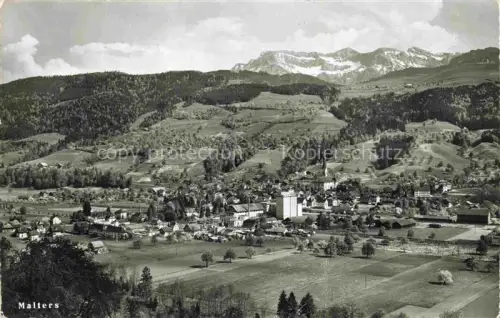 AK / Ansichtskarte Malters Luzern LU Dorf Kirche Berge Panorama Felder Wald Pilatus