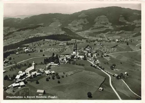 AK / Ansichtskarte Hemberg Toggenburg SG Fliegeraufnahme Toggenburg Kurort Kirche Daecher Wiesen Huegel