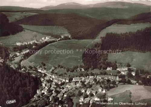 AK / Ansichtskarte Wildemann Harz Goslar Niedersachsen Luftbild Oberharz Wald Tal Wohnhaeuser Kirche Bergdorf