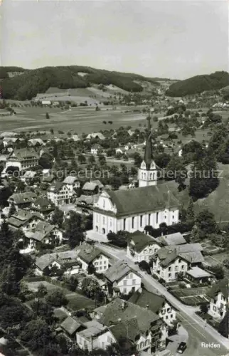 AK / Ansichtskarte Reiden Willisau LU Kirche Dorf Felder Huegel Wald Dorfzentrum Luftbild