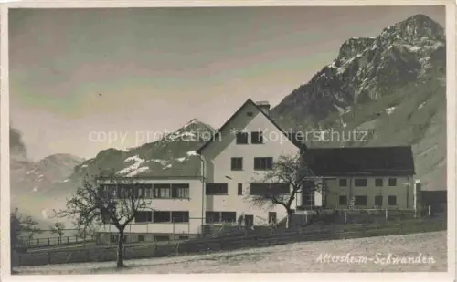 AK / Ansichtskarte Schwanden Glarus GL Altersheim Berge Schnee Gebaeude Baeume Alpenlandschaft