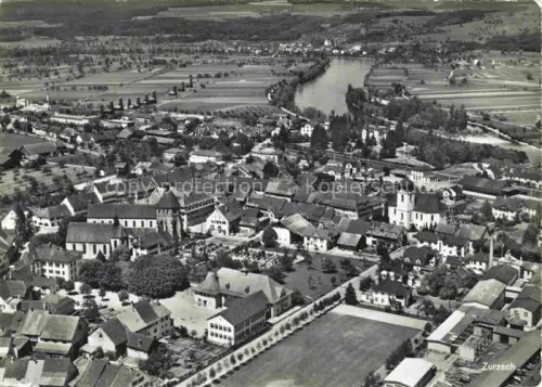 AK / Ansichtskarte Bad Zurzach AG Kirche Rhein Felder Ortskern Wohnhaeuser Baeume Bahnlinie