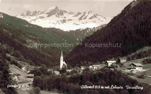 AK / Ansichtskarte Silbertal Montafon Vorarlberg AT Silbertal Montafon Lobspitze Kirchturm Bergtal Schneeberge Wald Haeuser Bergdorf