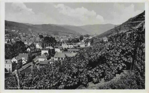 AK / Ansichtskarte Guebwiller Elsass 68 Haut-Rhin Stadtpanorama Weinberge Tal Berge Kirche Haeuser