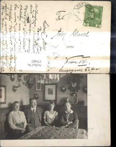 173487,Foto Ak Familie sitzt um Tisch Stube Jagd Geweihe a. Wand Mariazell