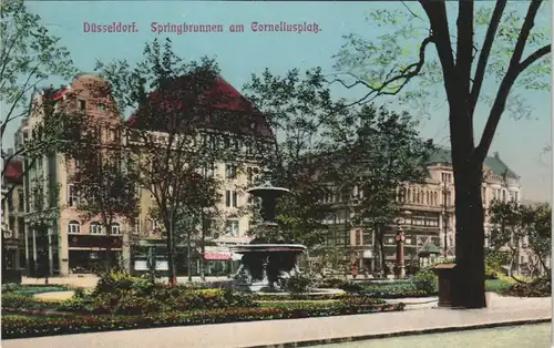 Düsseldorf Corneliusplatz Springbrunnen, div. Geschäfte & Lokale 1915   gelaufen mit Stempel DÜSSELDORF