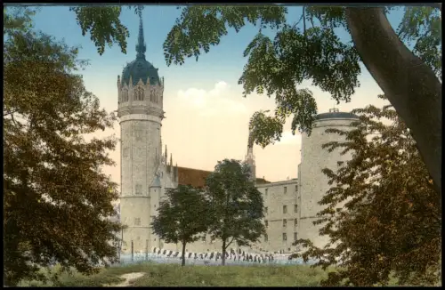 Ansichtskarte Lutherstadt Wittenberg Schloßkirche durch Bäume gesehen 1915