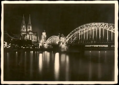 Ansichtskarte Köln Dom und Hohenzollernbrücke in Festbeleuchtung 1940